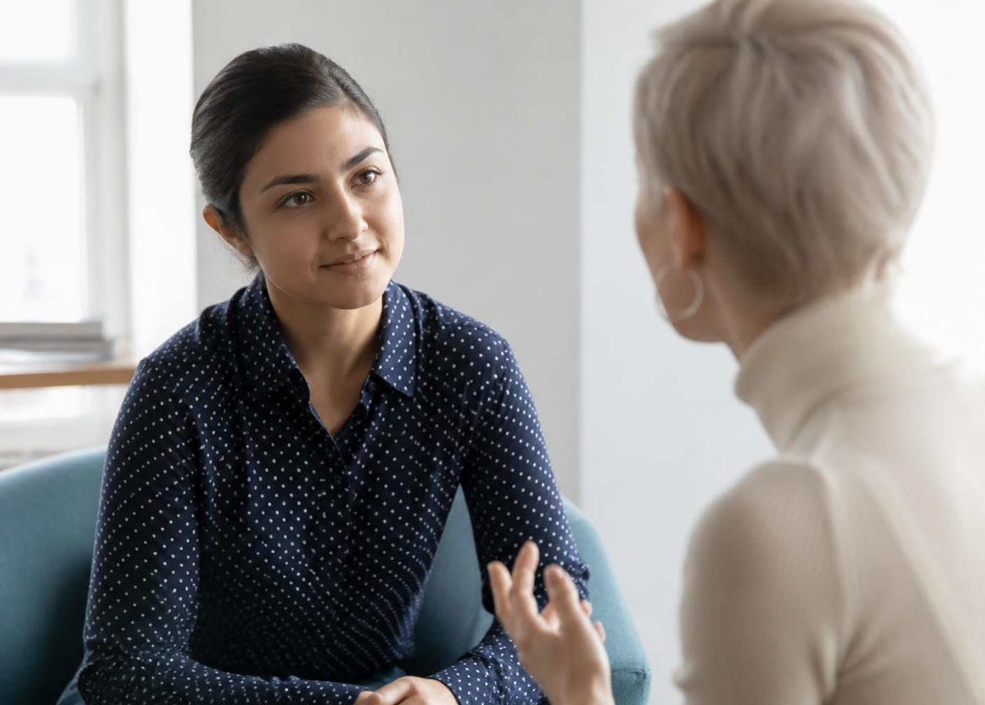 One person listening carefully to another during a private conversation